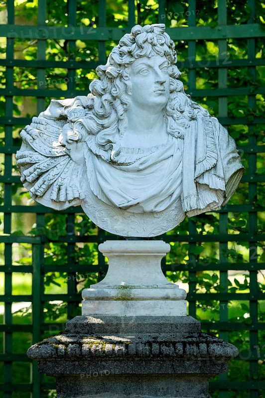 Decorative male bust in the garden archway