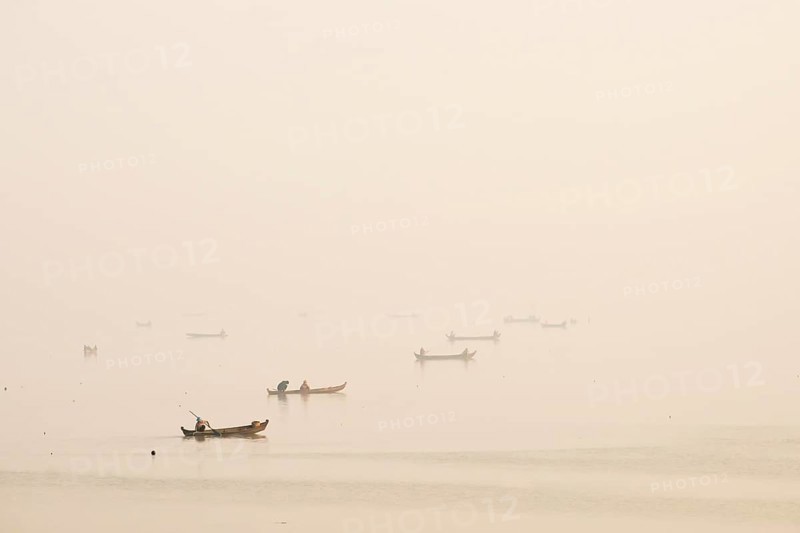 Fishermen in their boats in the morning light