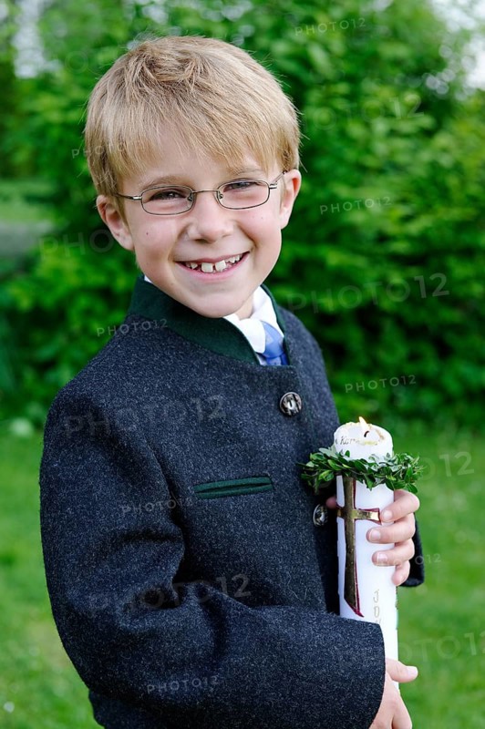 Boy holding a First Communion candle