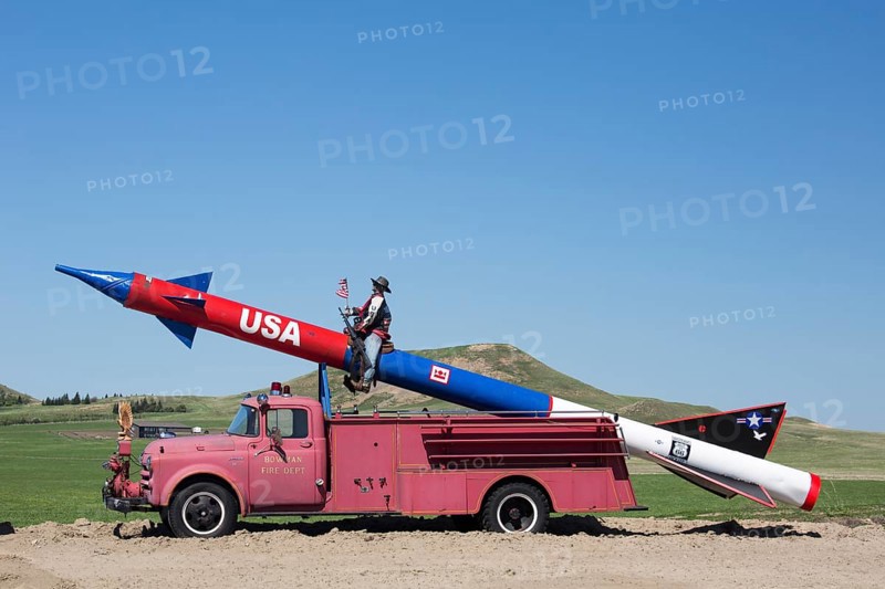 A missile mounted on an antique fire truck