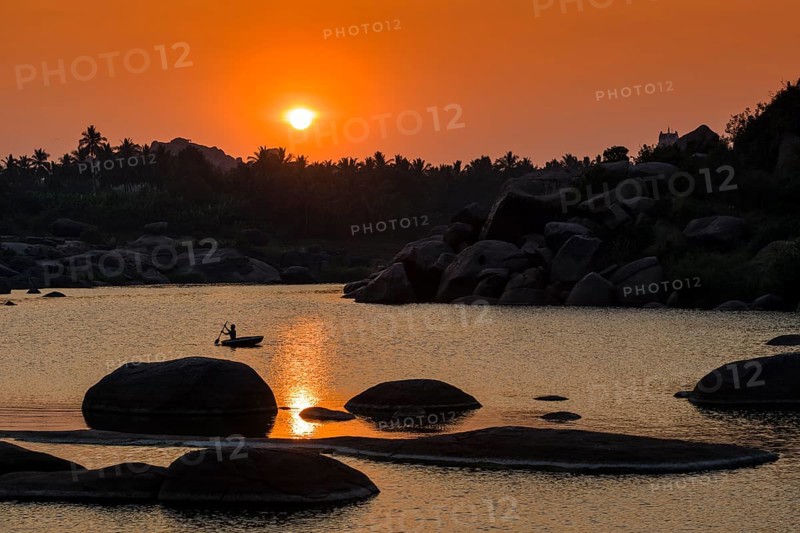 Sunset over Tungabhadra river and a part of the ruins of the former Vijayanagara Empire