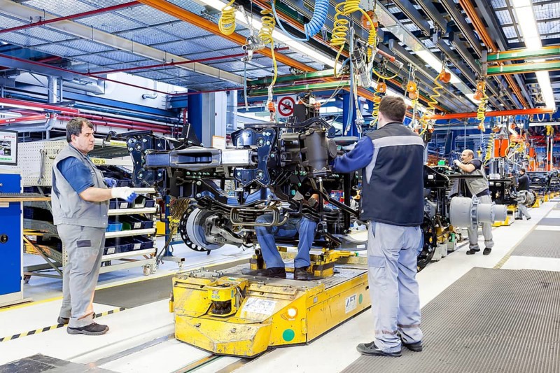 Employees assembling a chassis at MAN Truck and Bus AG