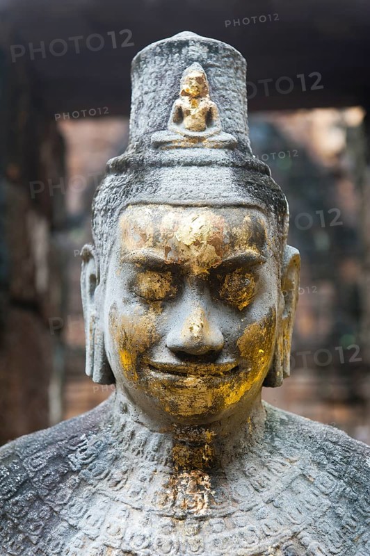 Buddhist statue of Bodhisattva Avalokiteshvara with offerings in the temple