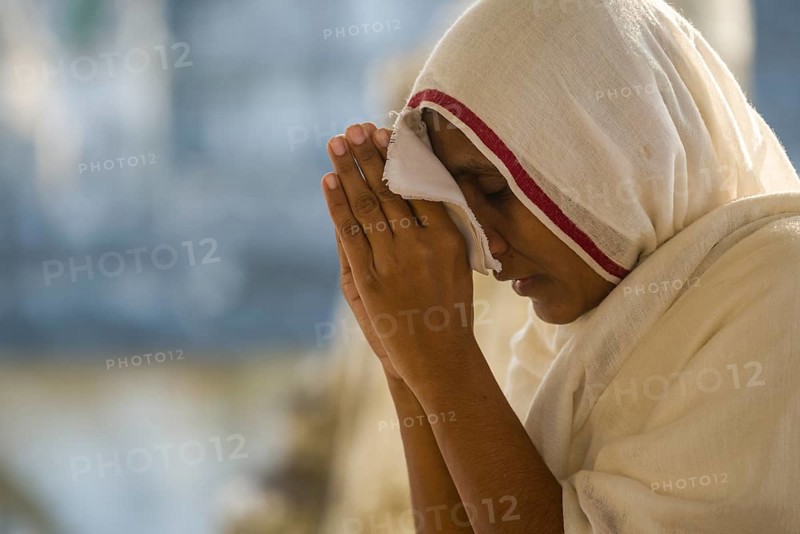 A Jain nun praying at a temple