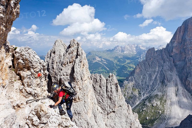 Mountain climber ascending Plattkofel Mountain along the Oskar-Schuster Stieg climbing route