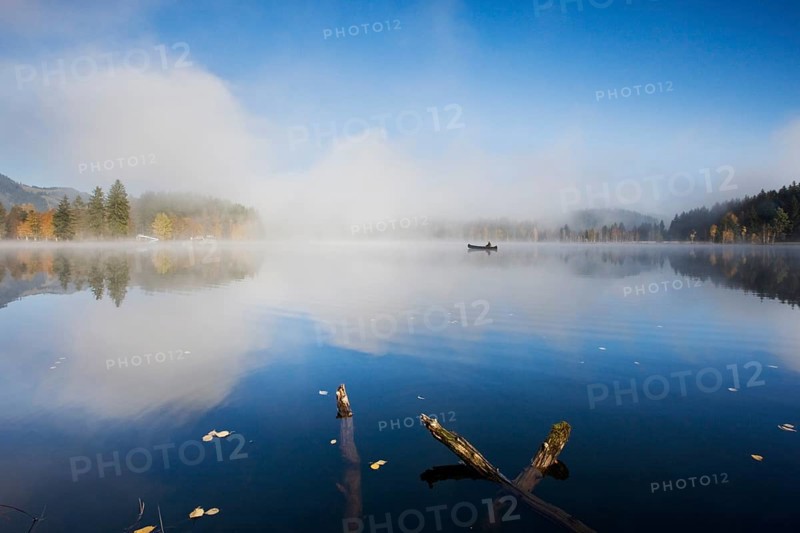 Schwarzsee with fishing boat in the morning mist
