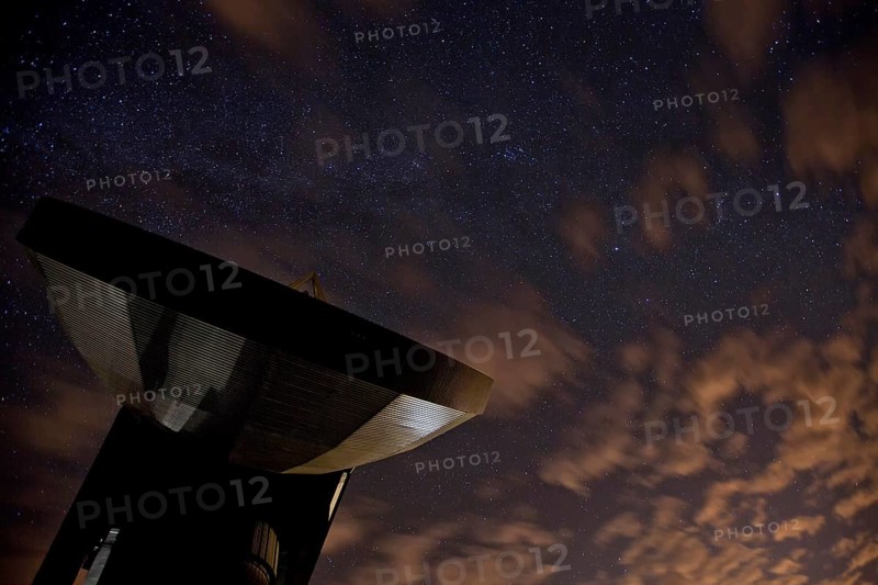 Satellite earth station in front of the night sky