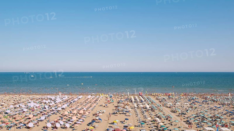View of a beach with sunshades and sun beds in the afternoon