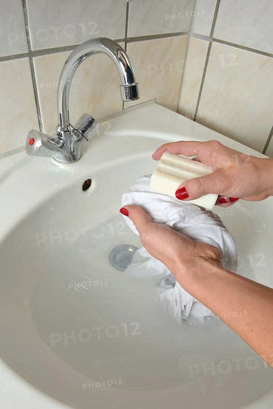 Washing by hand with German curd soap in a washbasin