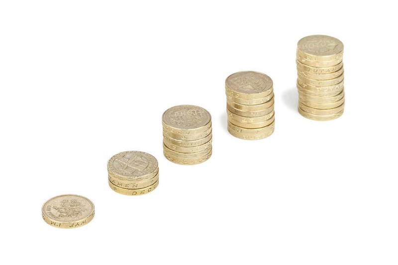 Piles of UK sterling pound coins