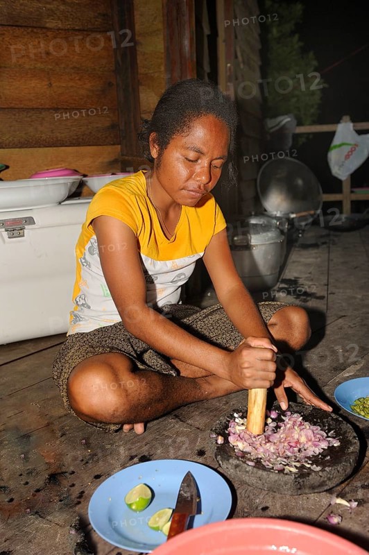 Papuan woman preparing food