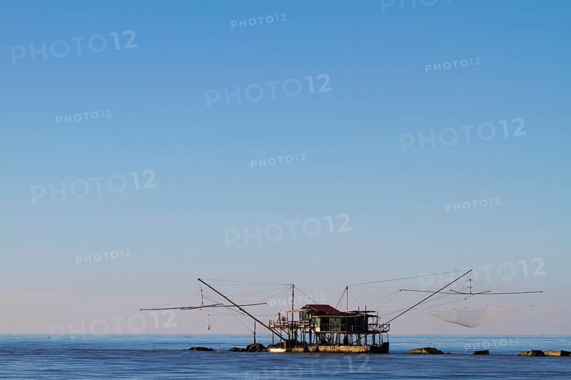 Fisherman's house with nets over the sea in Marina di Pisa