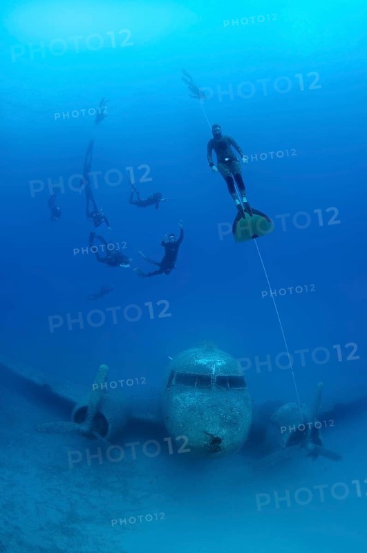 Freedivers at plane wreck Douglas Dakota