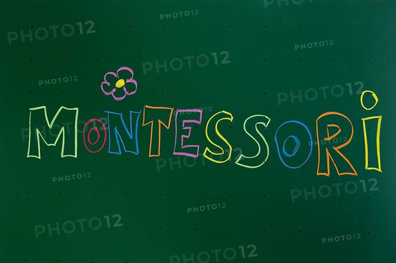 Montessori' written with chalk on a blackboard