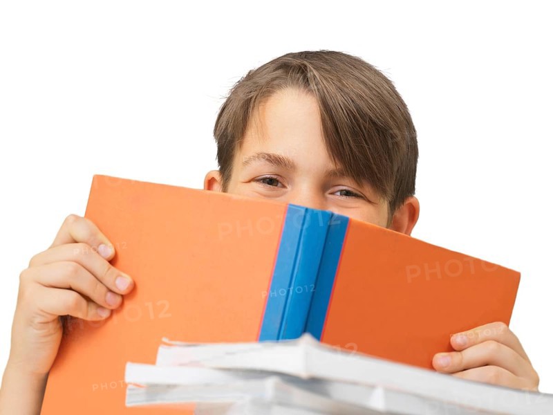 Schoolboy behind a school book