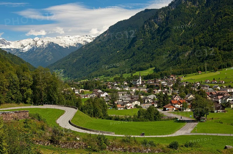 Winding road in front of the village of Linthal