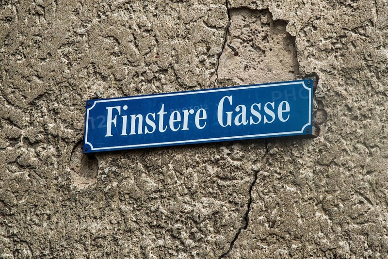 Street sign Finstere Gasse or Dark Alley