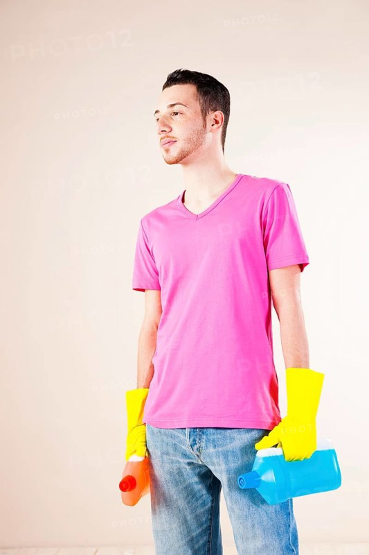 Man holding bottles of cleaning agents in his hands