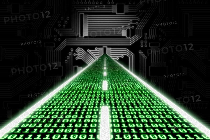 Road made of binary code leading towards a stylized circuit board