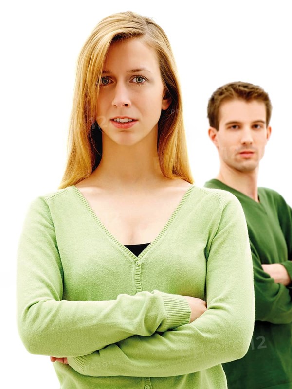 Young couple standing with their arms crossed
