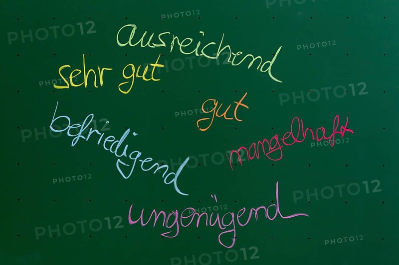 German terms for school grades written with chalk on a blackboard