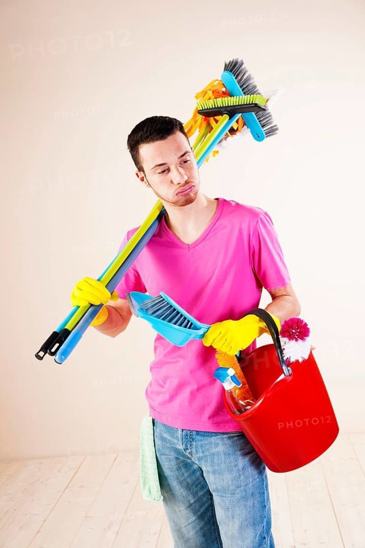 Man holding cleaning products in his hands