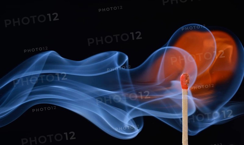 Lit matchstick with a flame and smoke