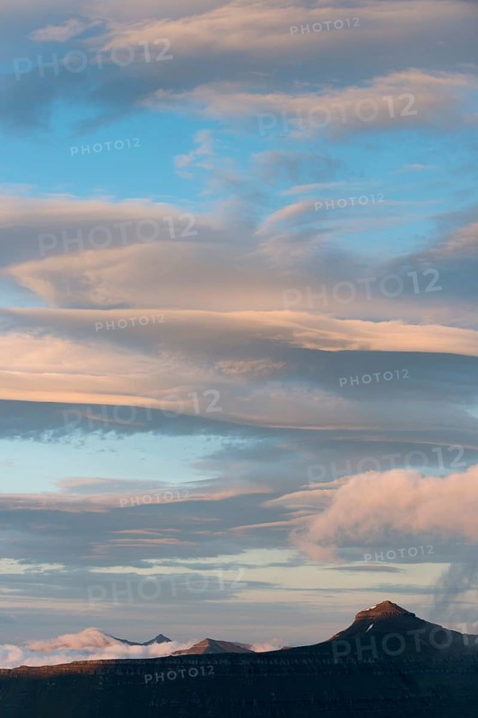 Mountain landscape in the evening light with a cloudy sky