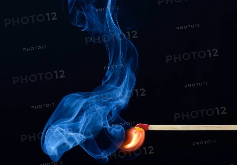 Lit matchstick with a flame and smoke