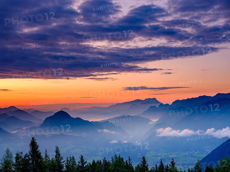 Blue mountain silhouettes at sunrise