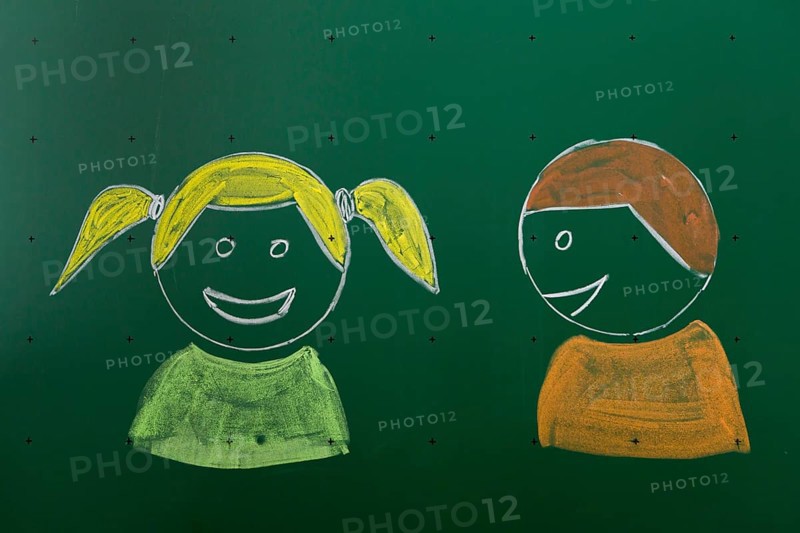 Two children drawn with chalk on a blackboard