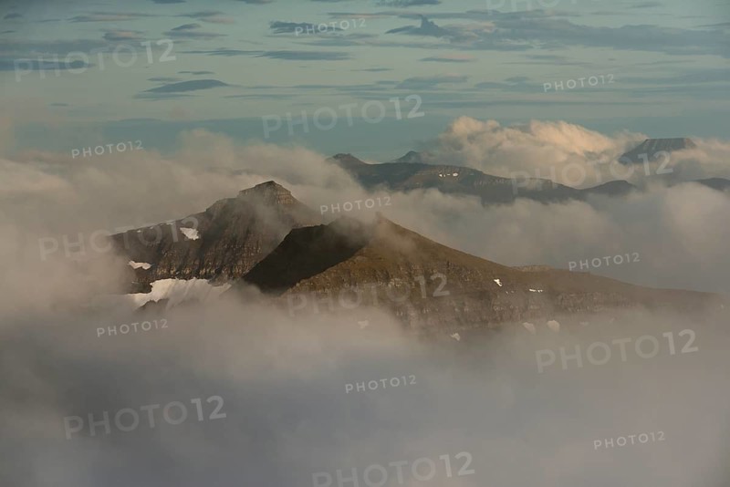 Mountain landscape in the evening light with looming clouds