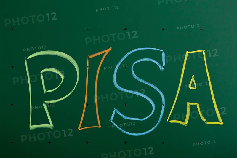 PISA' written with chalk on a blackboard