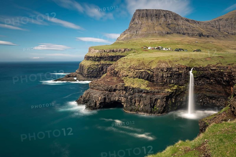 Waterfall on the cliffs near a village