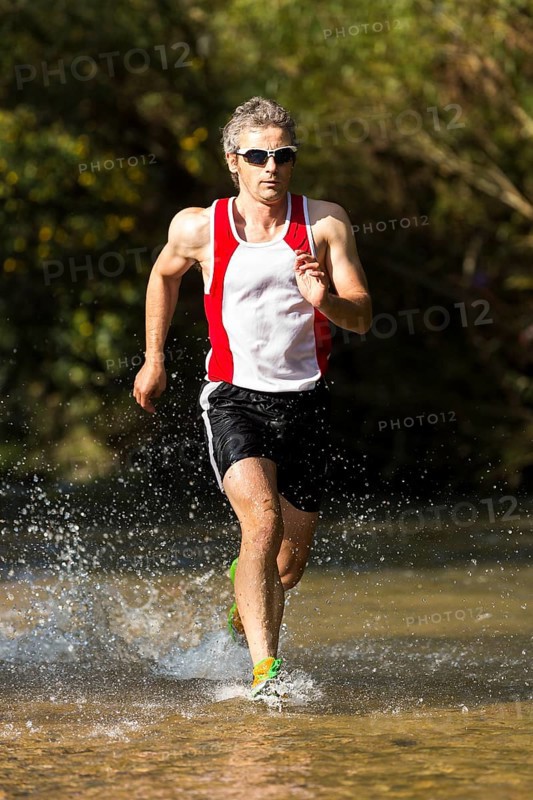 Jogger running through a stream