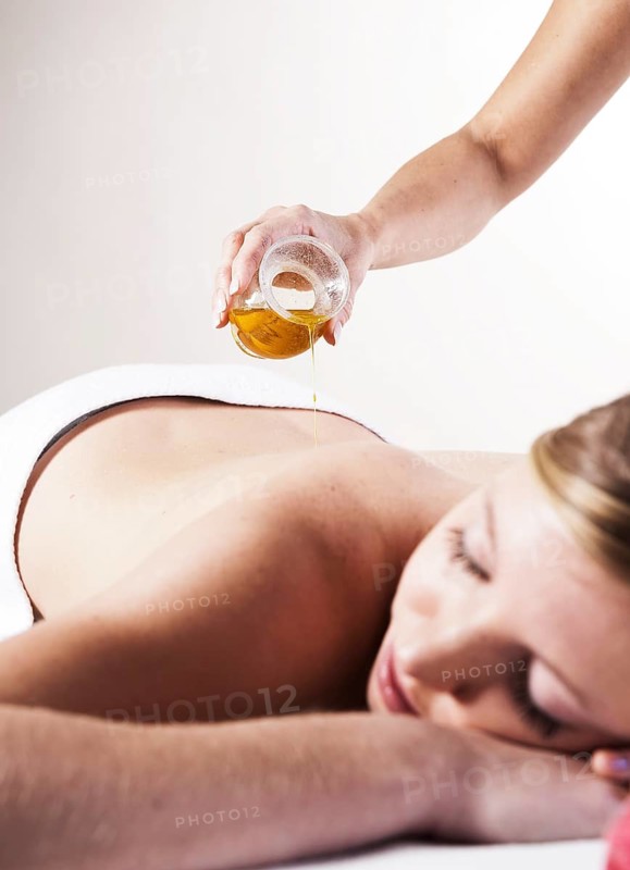 Young woman about to receive a massage with oil
