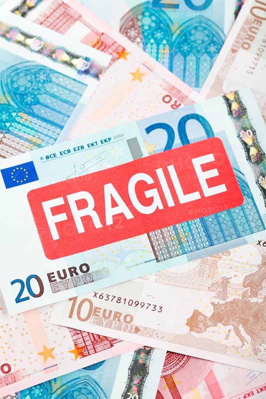 Euro banknotes with a 'Fragile' sticker
