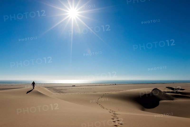 Man walking in the dune belt of Long Beach