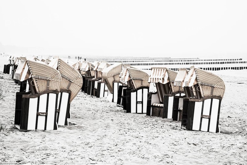 Roofed wicker beach chairs on the beach