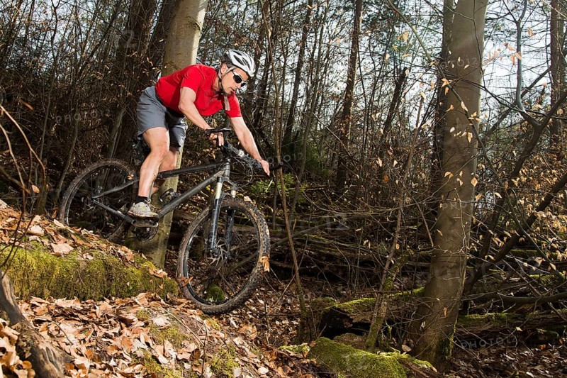 Cyclist on a mountainbike riding through a forest
