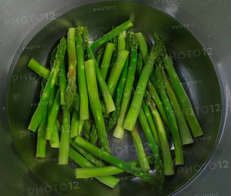 Fresh green Garden asparagus (Asparagus officinalis) in an aluminium bowl