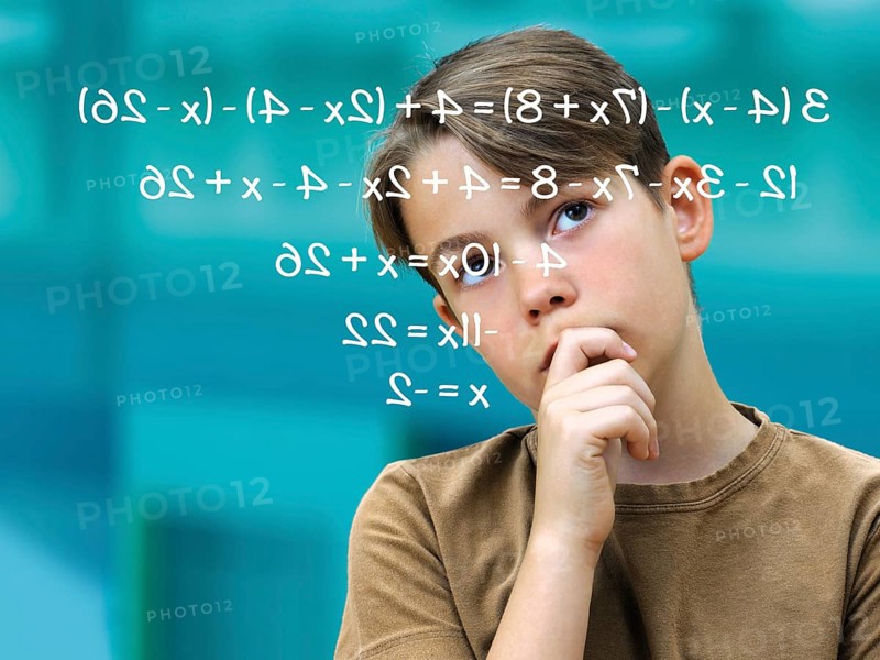 Schoolboy pensively in front of a math problem