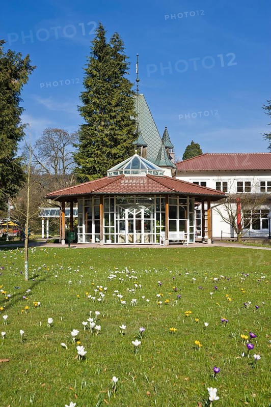 Historic Kurhaus with a pavilion and crocuses in the lawn