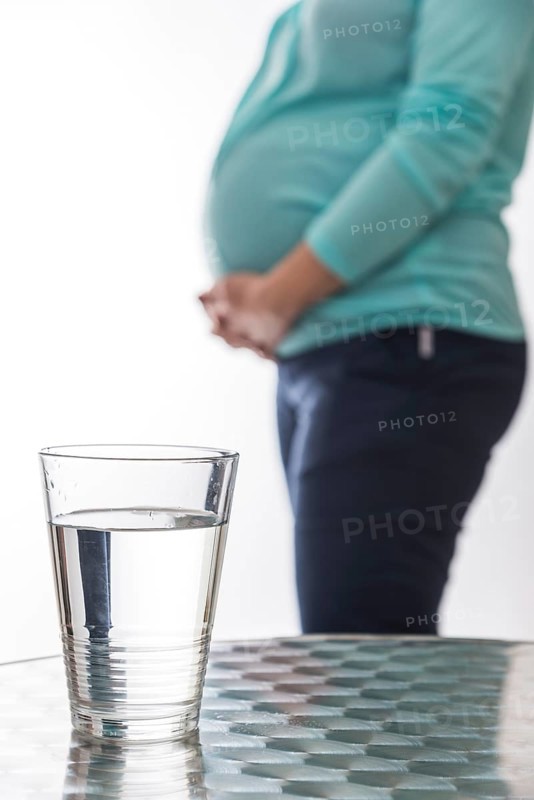 A glass water is resting on a table