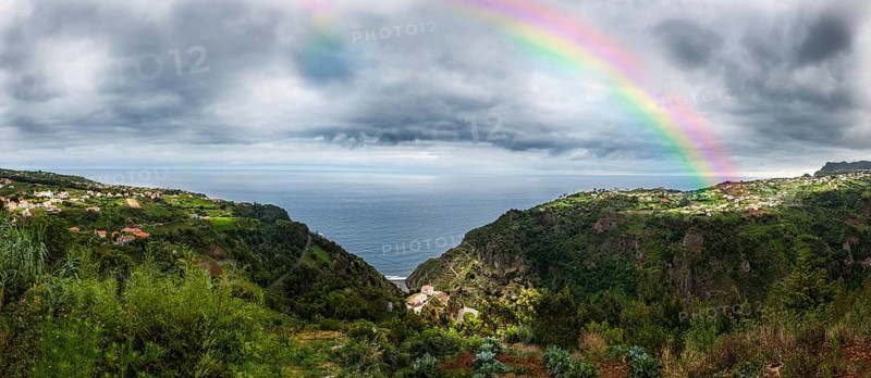Rainbow above the cliffs at Arco de Sao Jorge
