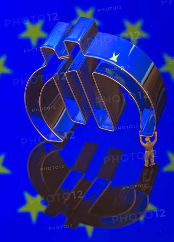 Miniature figure of a worker is carrying the Euro-symbol