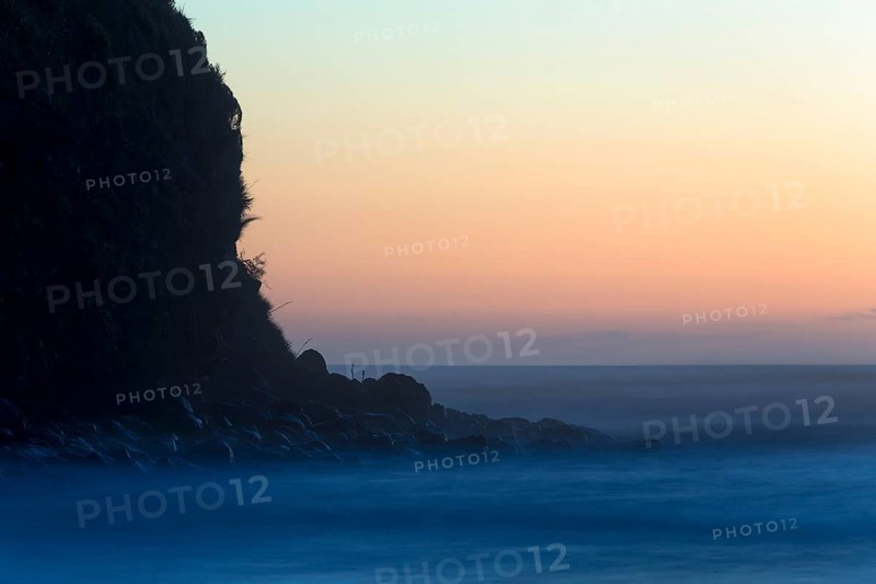 Cliffs and surf after sunset