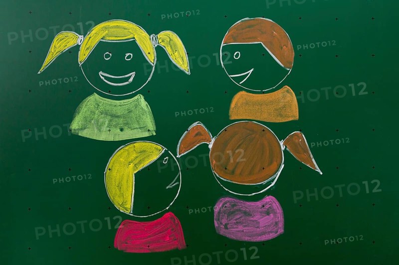 Four children drawn with chalk on a blackboard