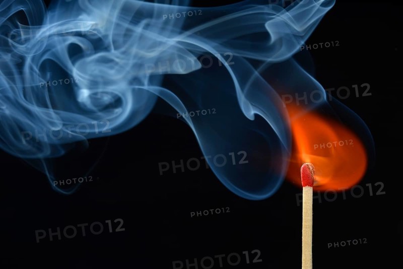 Lit matchstick with a flame and smoke