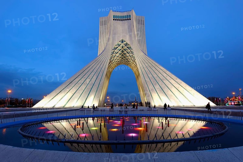 Illuminated Azadi Tower at blue hour